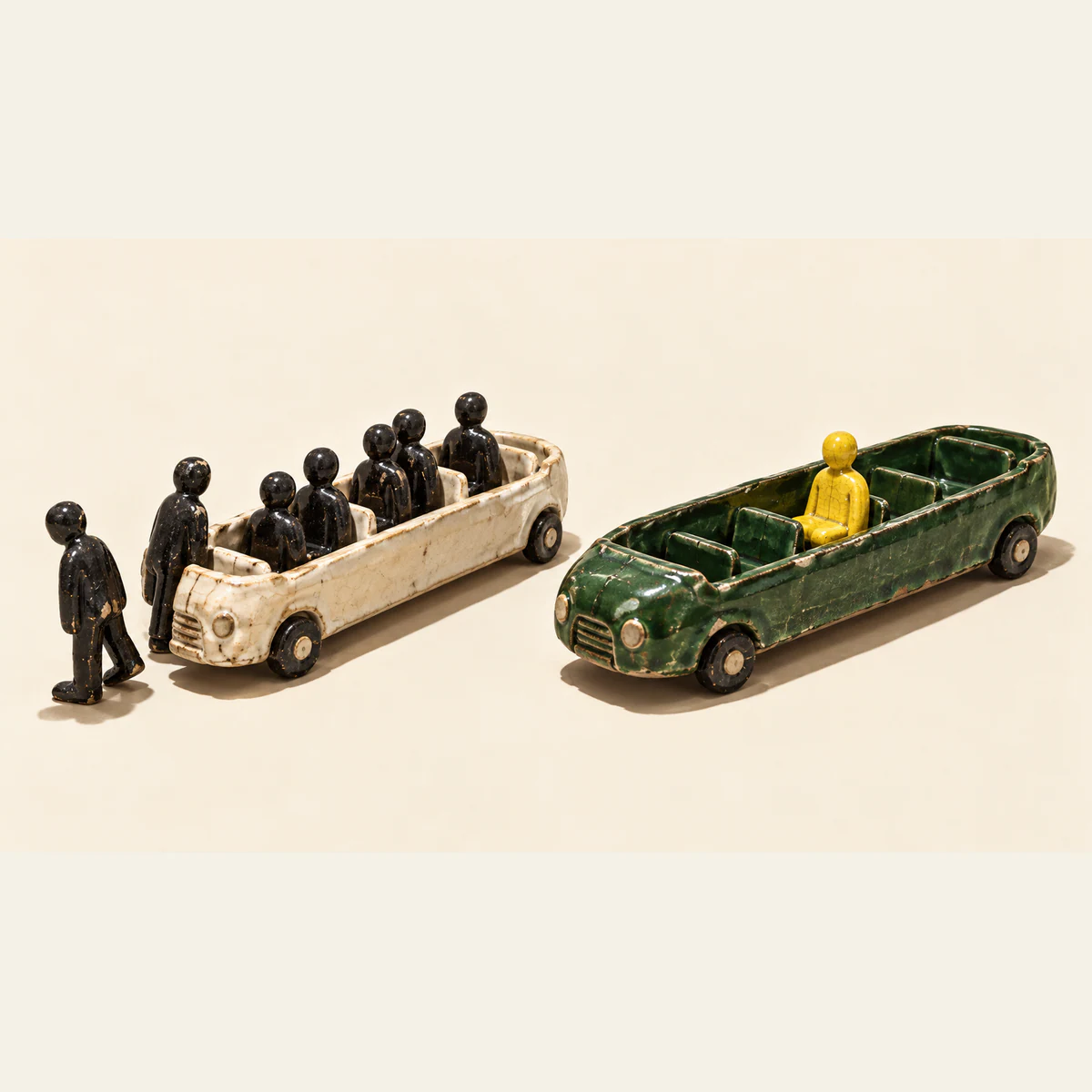 Two chipped ceramic passenger vehicles on an ivory background: an ivory vehicle holds several black figures, with two more beside it, while a green vehicle carries one yellow figure surrounded by empty seats.